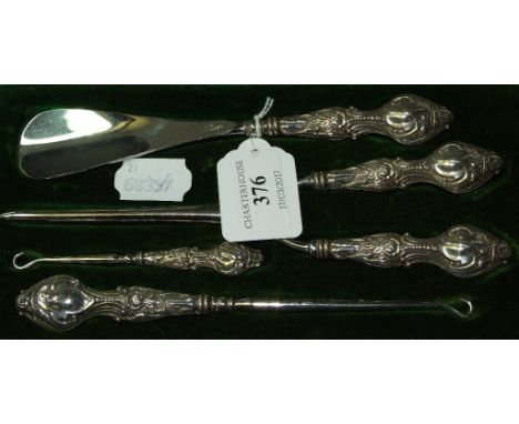 An Edwardian silver dressing set, comprising a shoehorn, a pair of glove stretchers, and two button hooks, Birmingham 1905, c