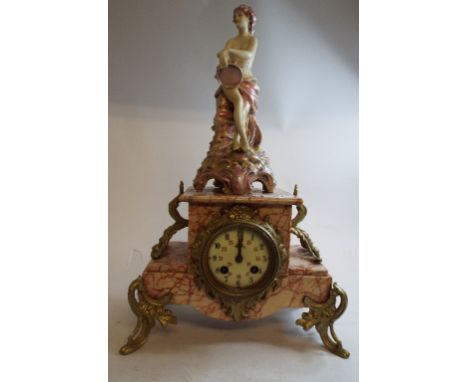 A mantel clock, the marble case applied a seated figure of a lady, 45.5 cm high