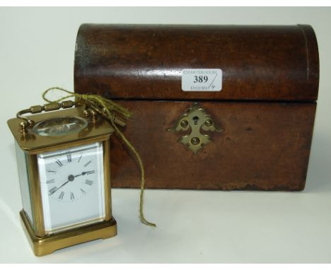 A brass carriage clock, 13 cm high, a domed top stationery box, and two miniatures (4)