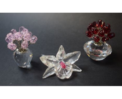 A Swarovski Crystal group, Vase of Roses, 283394, an Orchid, 869948, and other botanical figures, all boxed (8)   Condition r