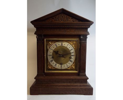 A bracket clock, fitted an eight day movement striking on four gongs, in an oak case, 41 cm high, with a bracket (2)