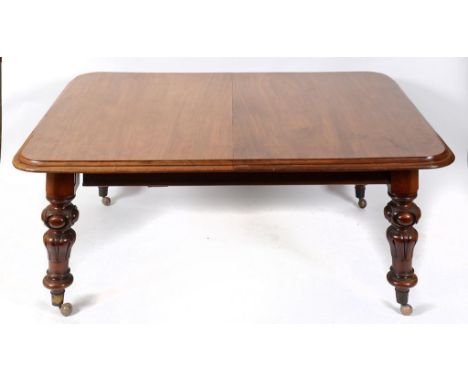 A Victorian mahogany extending dining table, inset three extra leaves, on carved legs, 305 cm (10 feet)  See illustration   C