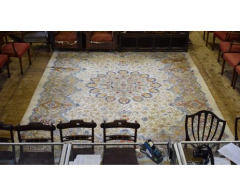 A Persian Kashan carpet, with a central medallion on a cream ground, 431 x 321 cm