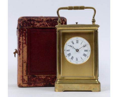 A carriage clock, with repeat, the 5.5 cm diameter enamel dial with Roman numerals, within a brass mask with engine turned de