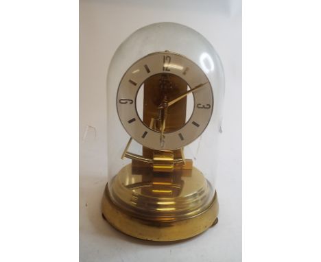 A Kundo electronic timepiece, under a glass dome, 23 cm high, an American style oak shelf clock, other clocks and a barometer