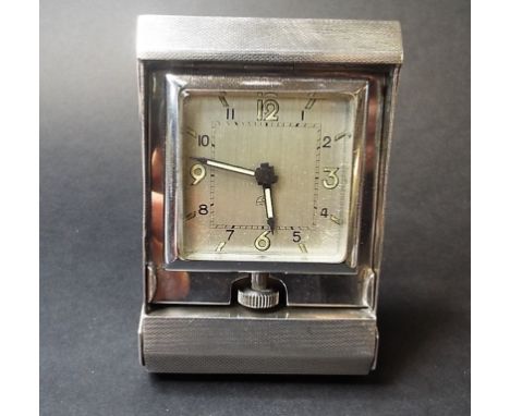 A silver folding travelling clock, initialled and dated 1938, Birmingham 1937, a silver pocket watch and chain, a brass pocke
