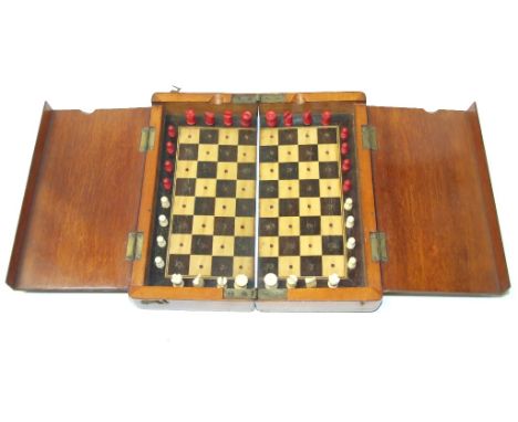 A mahogany travelling chess/draughts set, with stained and natural bone pieces, 20 cm wide