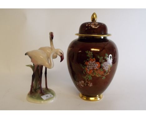 A Carlton Ware Rouge Royale vase and cover, 27 cm high, a pottery group, of two flamingo, 22 cm high, a pair of treen bookend