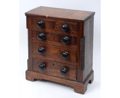 A Victorian oak and elm tabletop/miniature chest, of two short and three graduated long drawers, on bracket feet, 38 cm wide 