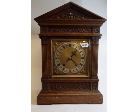 A bracket clock, the 16 cm square brass dial with Roman numerals, fitted an eight day movement, striking on a gong, in an oak