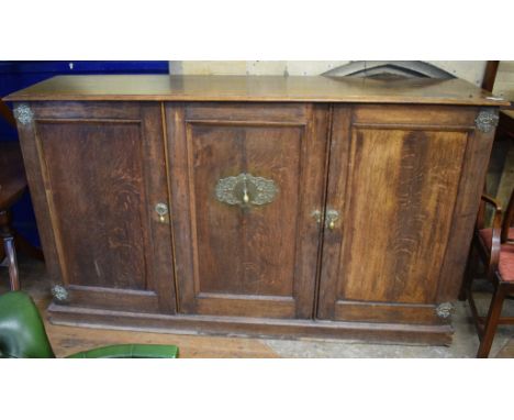 An oak three door cupboard, 194 cm wide, a set of eight George III style mahogany dining chairs, and a Regency style twin pil