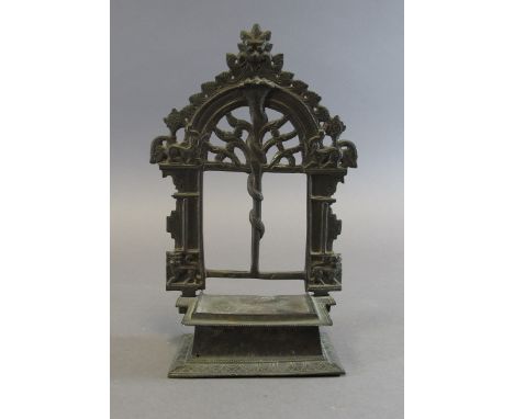 A BRASS SHRINE India, 19th century probably Jain, in two sections, comprising a rectangular raised base and openwork prabha, 