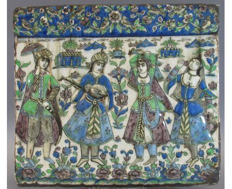 A QAJAR MOULDED TILE DEPICTING REVELLERS Probably Teheran, Persia, Second half 19th century polychrome-glazed fritware, of re