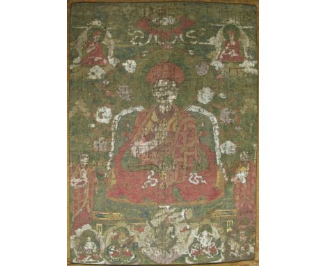 A THANG-KA DEPICTING A LAMA Bhutan, 18th century pigment with gold on cloth, silk surround with Chinese brocade panel below, 