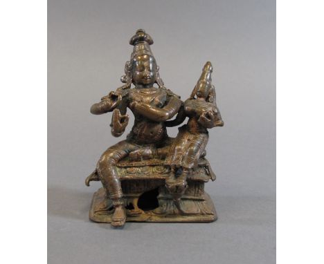 KRISHNA VENUGOPALA WITH HIS CONSORT South India, 16th/17th century seated together on a rectangular throne, the four-armed de
