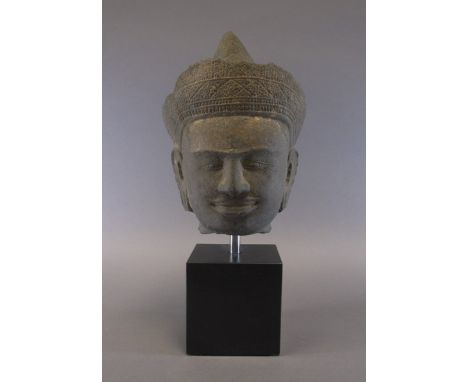 AN ANGKOR WAT HEAD OF A DEITY, PROBABLY VISHNU Cambodia, second half 11th century grey sandstone, wearing elaborate flared cr