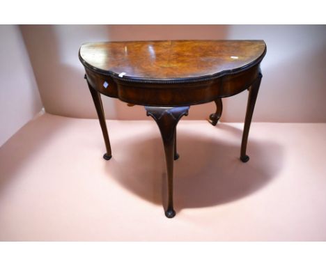 William IV walnut fold over card table with back pull out support leg, standing on slender cabriole legs.