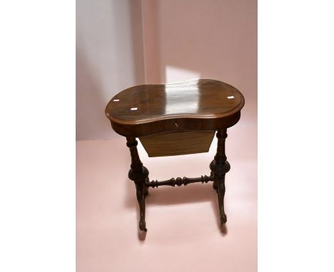 A Victorian mahogany kidney shaped sewing table with lift up top to reveal box wood interior with compartment and pierced lid