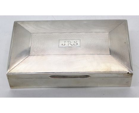 An Elizabeth II silver cigarette box, of rectangular shape with engine turned cover, cartouche engraved J.R.S, with cedarwood