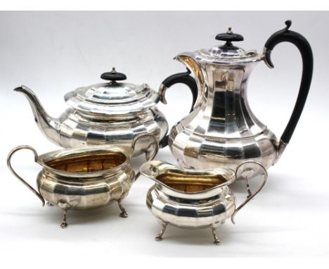 A George V silver four piece tea set, all of oval shaped form with angular panelled design, gilt interior to sugar and cream,