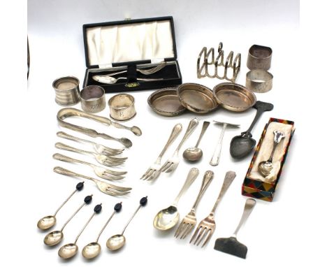 A small collection of silver to include; a George V silver toast rack, Birmingham, 1927; a set of three Chester silver pin di