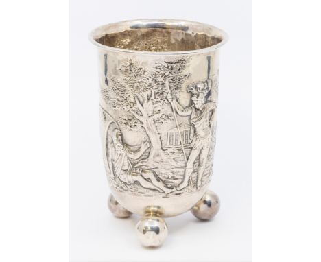 A late 19th century German silver beaker, embossed and chased with two knights in armour, a horse and a local man sitting aga
