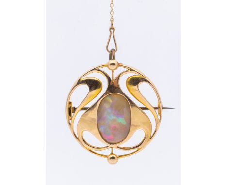An Arts & Crafts opal and 15ct gold brooch, comprising a circular scrolled open work form inset to the centre with an oval op