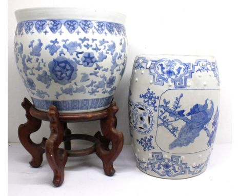 A large Chinese blue and white planter on stand with porcelain blue and white garden seat.