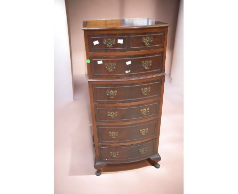 A reproduction slender chest of six drawers in mahogany along with a mahogany George III sofa table with drop ends.