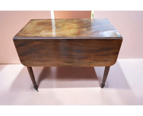 A George III mahogany fold-over card/games semi-circular table with tapered legs and green velvet playing surface along with 