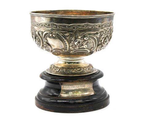 A late Victorian silver small rose bowl, of circular shape upon circular foot, elaborately embossed and chased with scrolls a