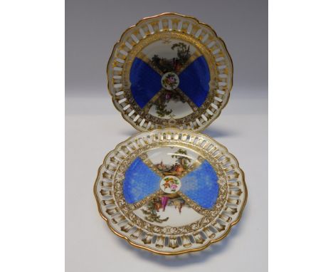 Two 19th century Meissen plates with reticulated borders and gilding, the centre decorated with two painted panels of lovers 