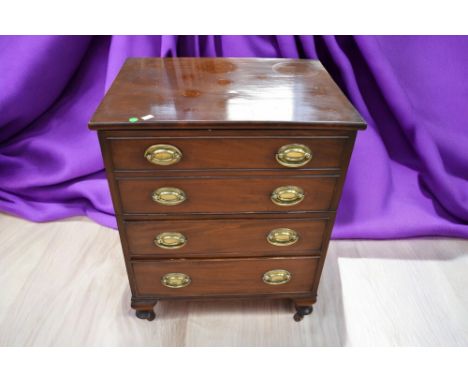 A mahogany George III commode converted to cabinet, a George III fold over tea table, Arts &amp; Crafts rocking chair and a r