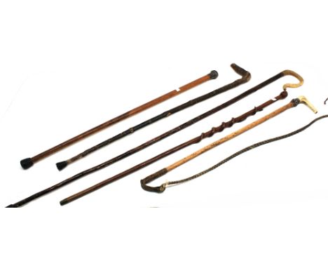 A collection of 19th Century walking sticks, some with silver collars/handles, horn handles, horse whip and a carved wooden A