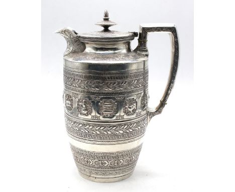 A Victorian Scottish silver hot water pot, heavily decorated with signs of the Zodiac to body surrounded by bands of foliage,
