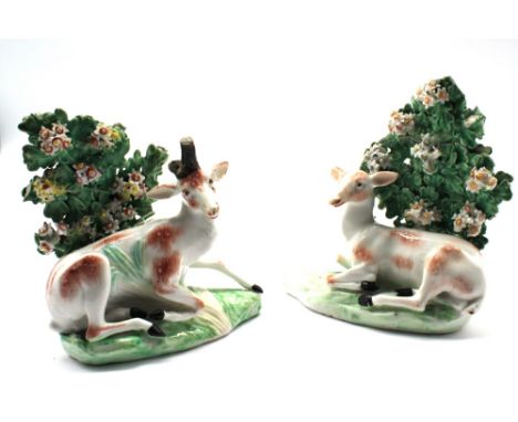 A pair of Derby porcelain bocage groups of recumbent stag and doe, circa 1765, patch amrks incised N, approx. 11cm high.  Fur