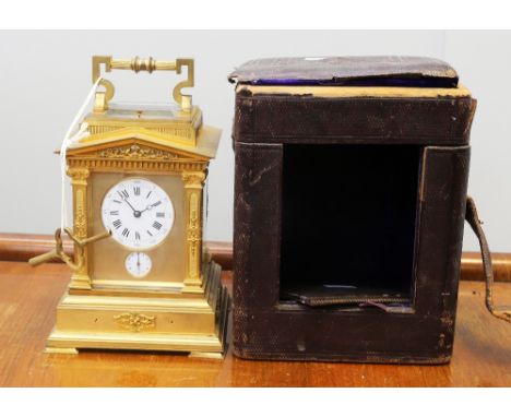 A 19th Century gilt metal French 8 day repeating mantle/travel clock, in Roman temple form with circular face with Arabic and