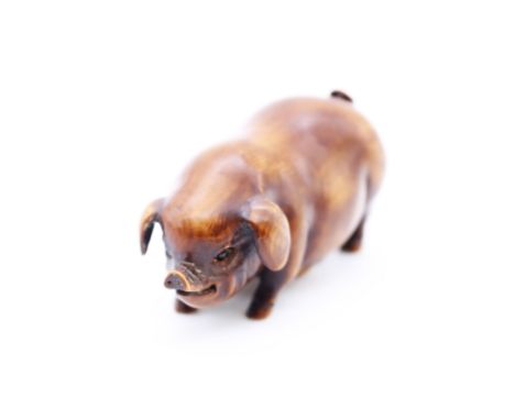 A 20th century Eastern hardwood netsuke in the form of a Pig, signed, approx. 6.2cm long.&nbsp;