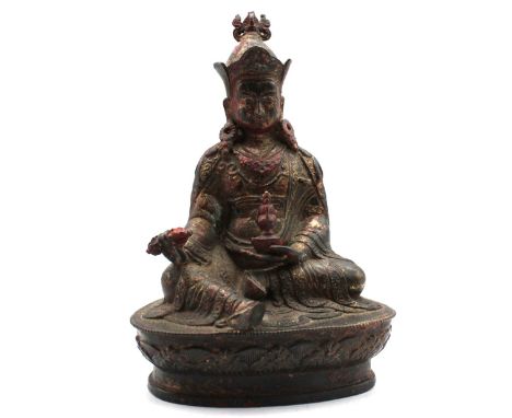 A 19th century or earlier Tibetan bronze figure of a Buddhist deity, possibly Maitreya, wearing a crown and holding an urn, c