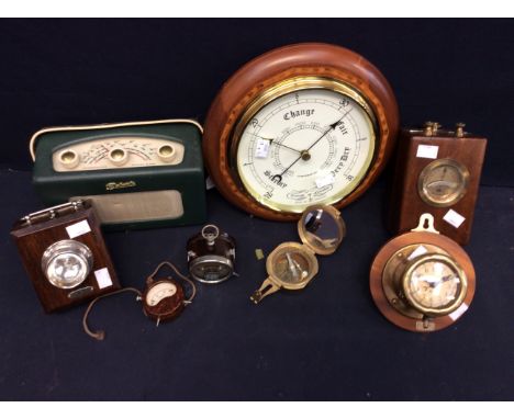 A late 20th Century reproduction round wall barometer, a mid 20th Century oak ever ready lamp, two Bakerlite volt meters, an 