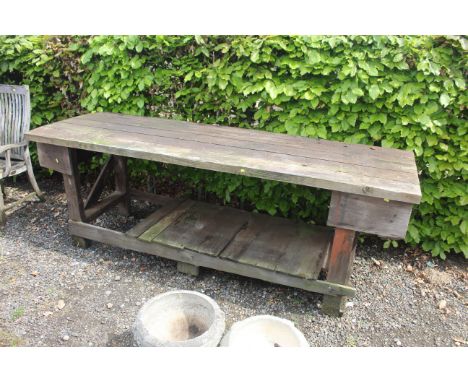 A large wooden carpenters work bench measuring approx. 8ft wide 