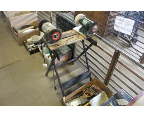 A Ryobi bench grinder together with a Parkside bench grinder, both mounted to a Black & Decker workmate