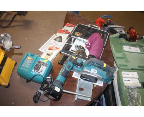 A Makita BKP180 cordless electric planer with manual. a Makita BTM50 cordless electric multi tool, a Makita DC18RA battery ch