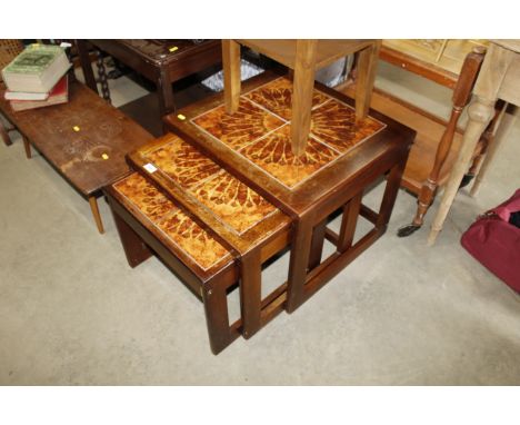 A teal and tile top nest of three occasional tables