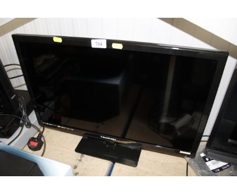 A Blaupunkt television with remote control and instruction manual