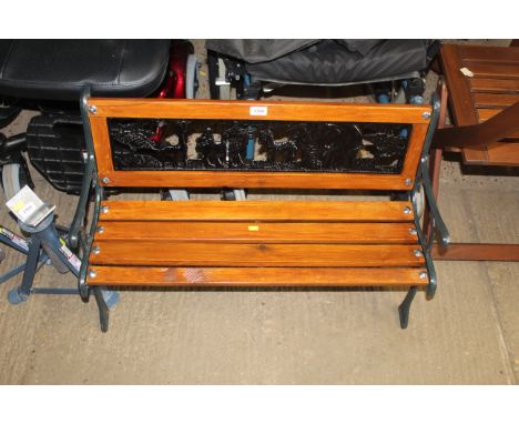A child's bench with ornate cast iron bench ends and a safari themed back rest 
