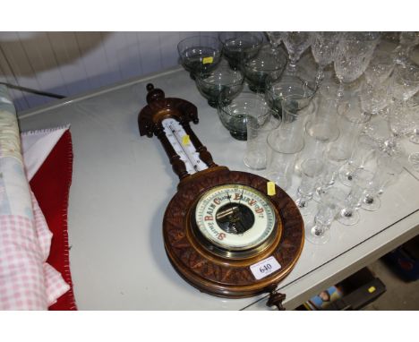 A barometer/thermometer contained in carved frame