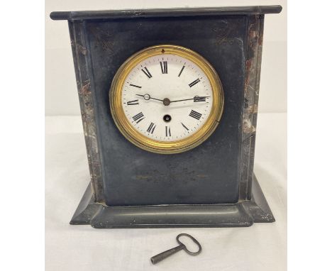 An antique black slate and marble mantle clock complete with key and pendulum.  Enamelled face, glass is missing from door.  