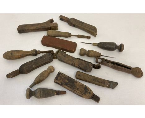 A collection of vintage wooden handled rug making tools and cutters.  
