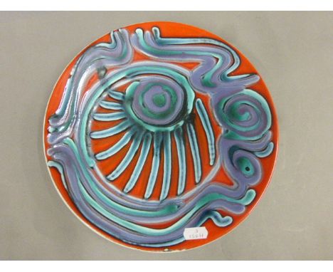 Poole Pottery plate shape 4 of abstract design with red ground, diameter 27cm